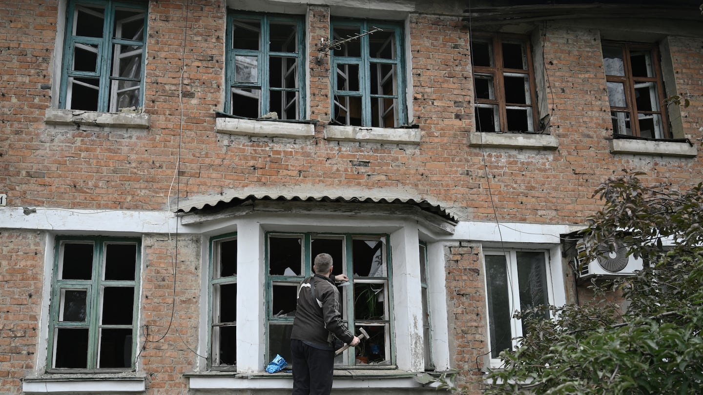 A resident cleared the shattered glass in a broken window in a residential building following a Russian strike on the village Shevchenkove, near the city of Pokrovsk, Donetsk region, Sunday, amid the Russian invasion of Ukraine.