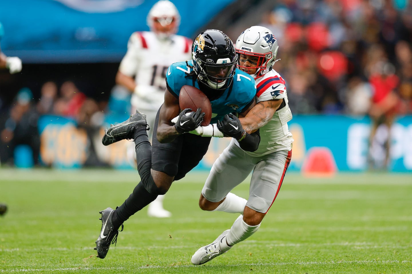 Patriots cornerback Christian Gonzalez (right) brought down Jaguars wide receiver Brian Thomas Jr. in the second quarter.