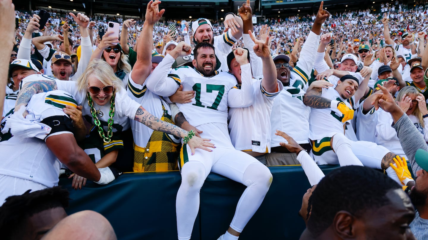 The Packers' Brandon McManus (center) joined the fans to celebrate after kicking the winning field as time expired.