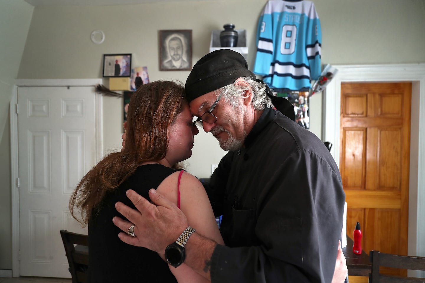 Arthur Barnard embraced his daughter-in-law, Kristy Strout, in her kitchen where she has a memorial for her late husband and Arthur’s son, Artie Strout. Artie Strout was killed while playing pool at Schemengees Bar & Grille last October during a mass shooting in Lewiston, Maine.