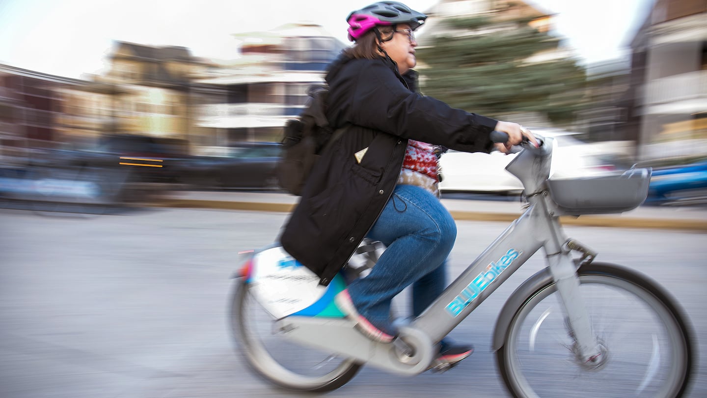 Molly Jennings picked up an e-bike at the Shawmut MBTA Station on her way home from work.