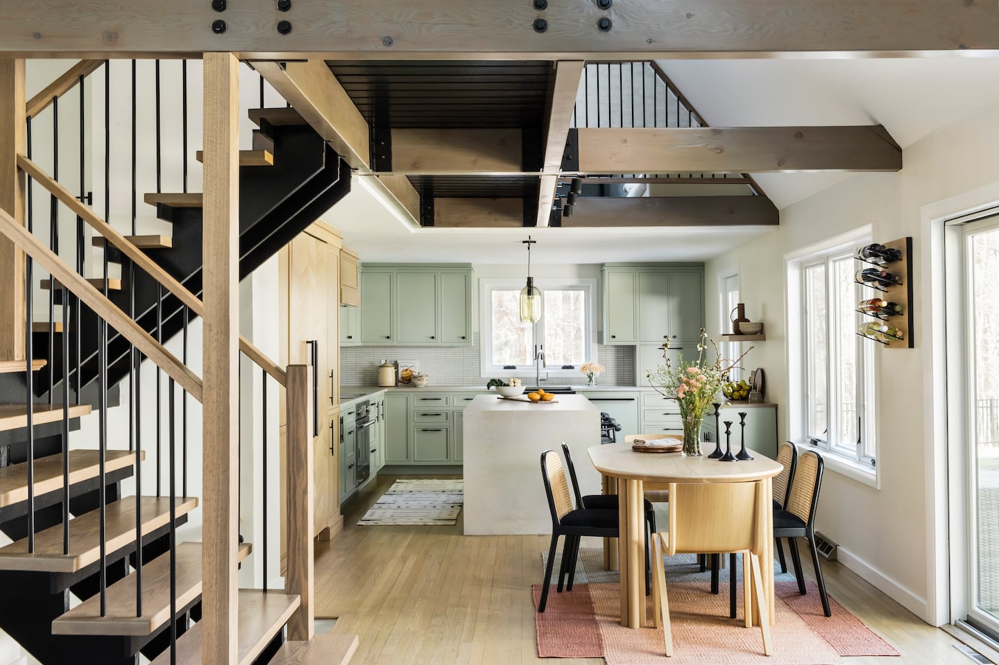 Designer Daniela Forte had to navigate multiple ceiling heights in the combined kitchen and dining area, and ensure that the various wood species of the cabinetry, floor, stair treads, and beams didn’t vary too much.