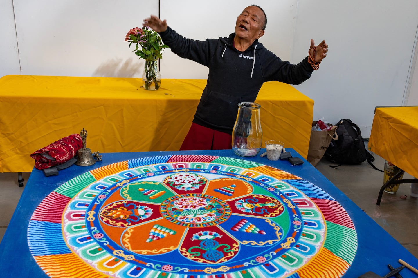 Tenzin Yignyen constructed a sand mandala from millions of grains of colorful sand at MassArt. After it is completed, it is wiped away, placed in a jar, and released in a river as a teaching on the development of compassion and the nature of impermanence.