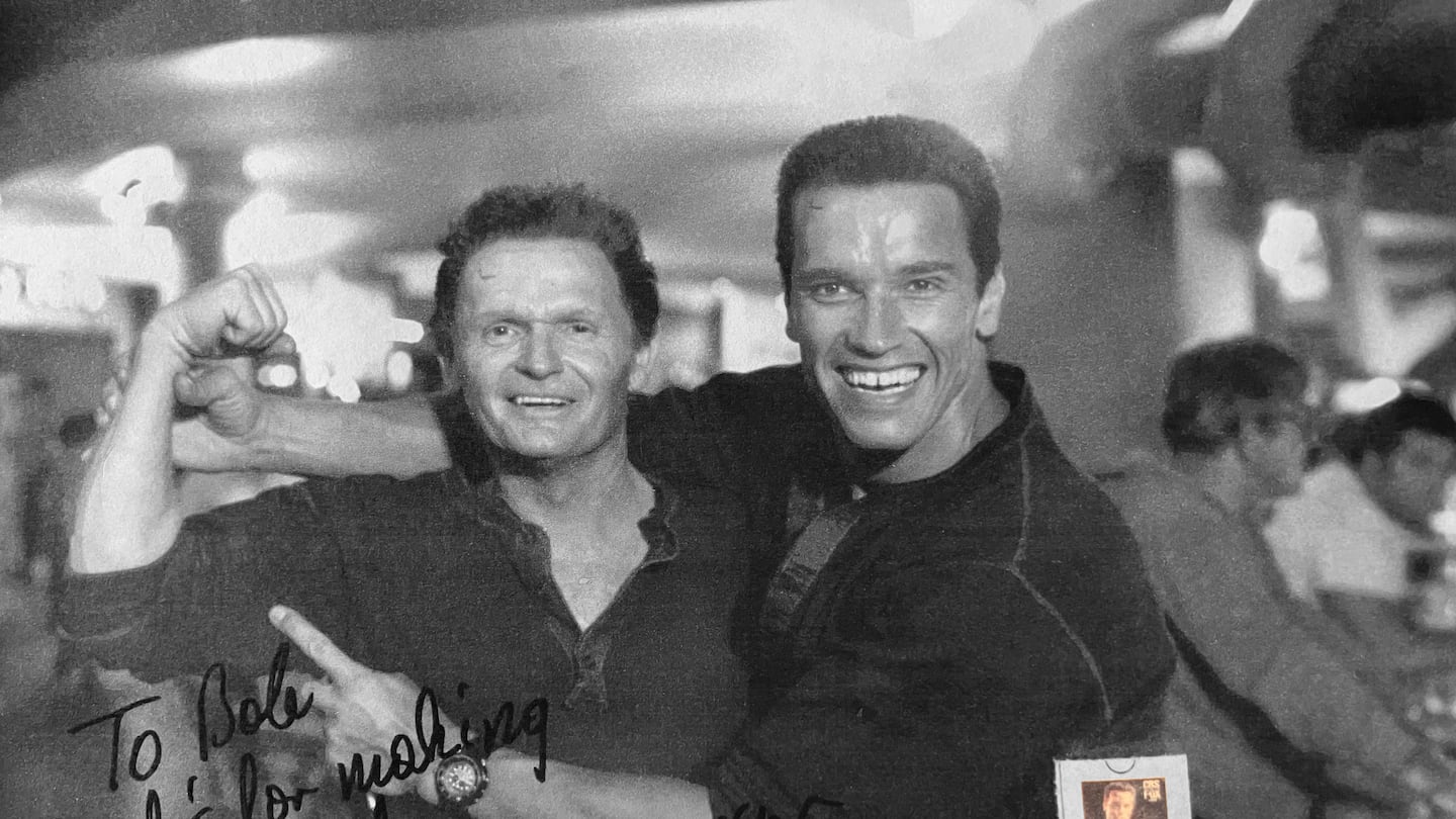 A photo provided via the Yerkes family shows Mr. Yerkes with Arnold Schwarzenegger during the filming of “Commando,” 1985, with a signed note from Schwarzenegger.