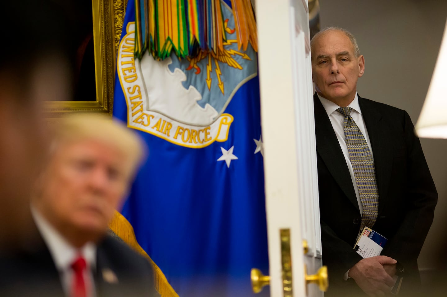 Former chief of staff John Kelly listened as then President Donald Trump met with North Korean defectors at the White House in Washington, Feb. 2, 2018.