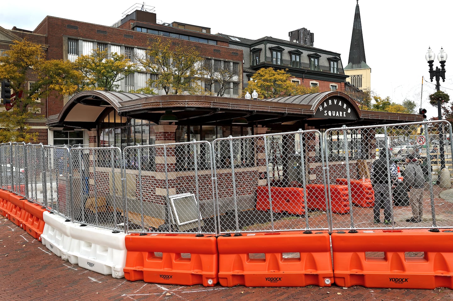 The long-fenced-off location of the Harvard Square kiosk. For decades it was home to landmark newsstand Out of Town News, which left in 2019.