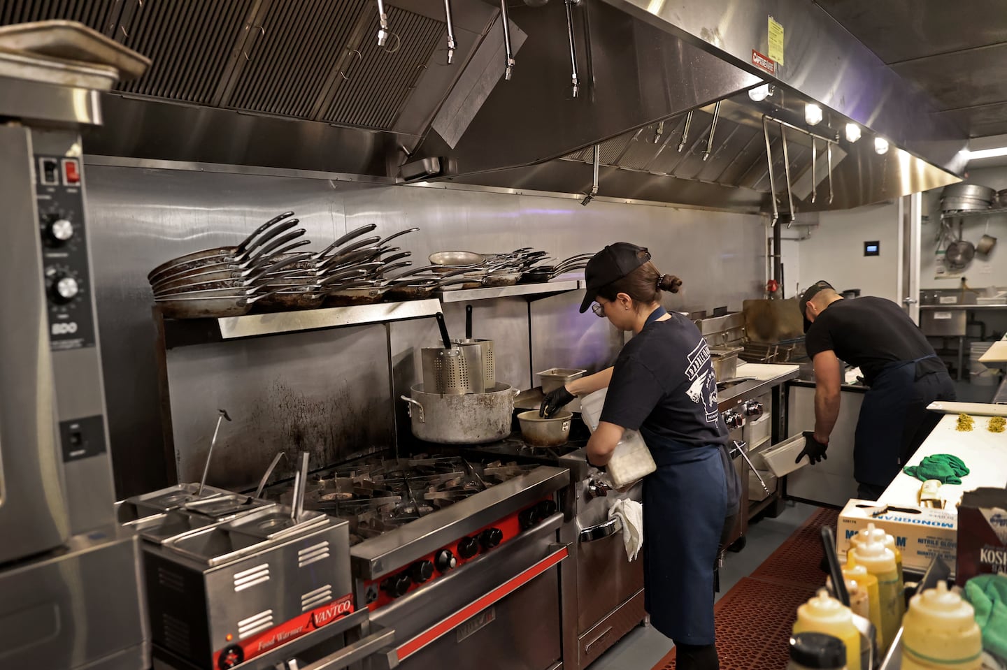 Boston, MA - 2/24/2023:TKTIPPINGÉ.A view of the kitchen area at Democracy Brewing. Restaurants implementing "kitchen fees," meant to narrow the gap between wages for tipped and untipped workers.  Democracy Brewing in downtown Boston instituted a 3.5% kitchen appreciation fee, which goes toward padding the wages for back-of-house workers.  (David L Ryan/Globe Staff ) SECTION: BUSINESS