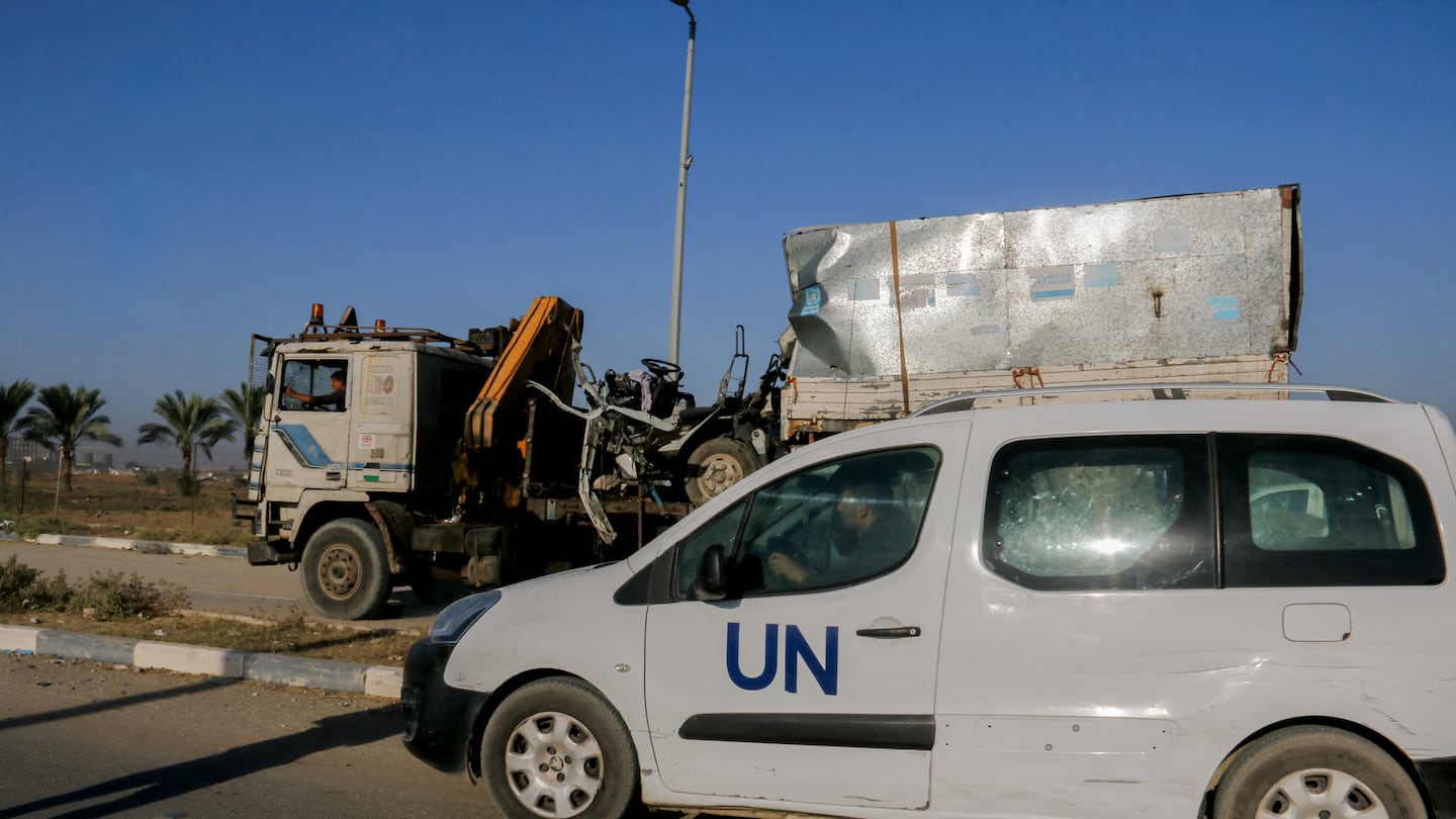 A United Nations (UN) vehicle near a destroyed van, with UN Relief and Works Agency (UNRWA) markings, following an Israeli strike on Salah al-Din Street south of Deir al-Balah, central Gaza, on Wednesday, Oct. 23, 2024.