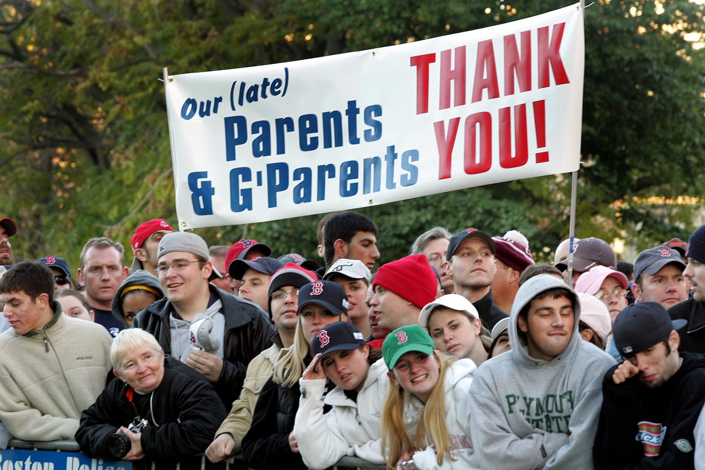 Fans gather near Fenway Park awaiting the arrival of the Red Sox after their overnight flight from St. Louis after winning the World Series.