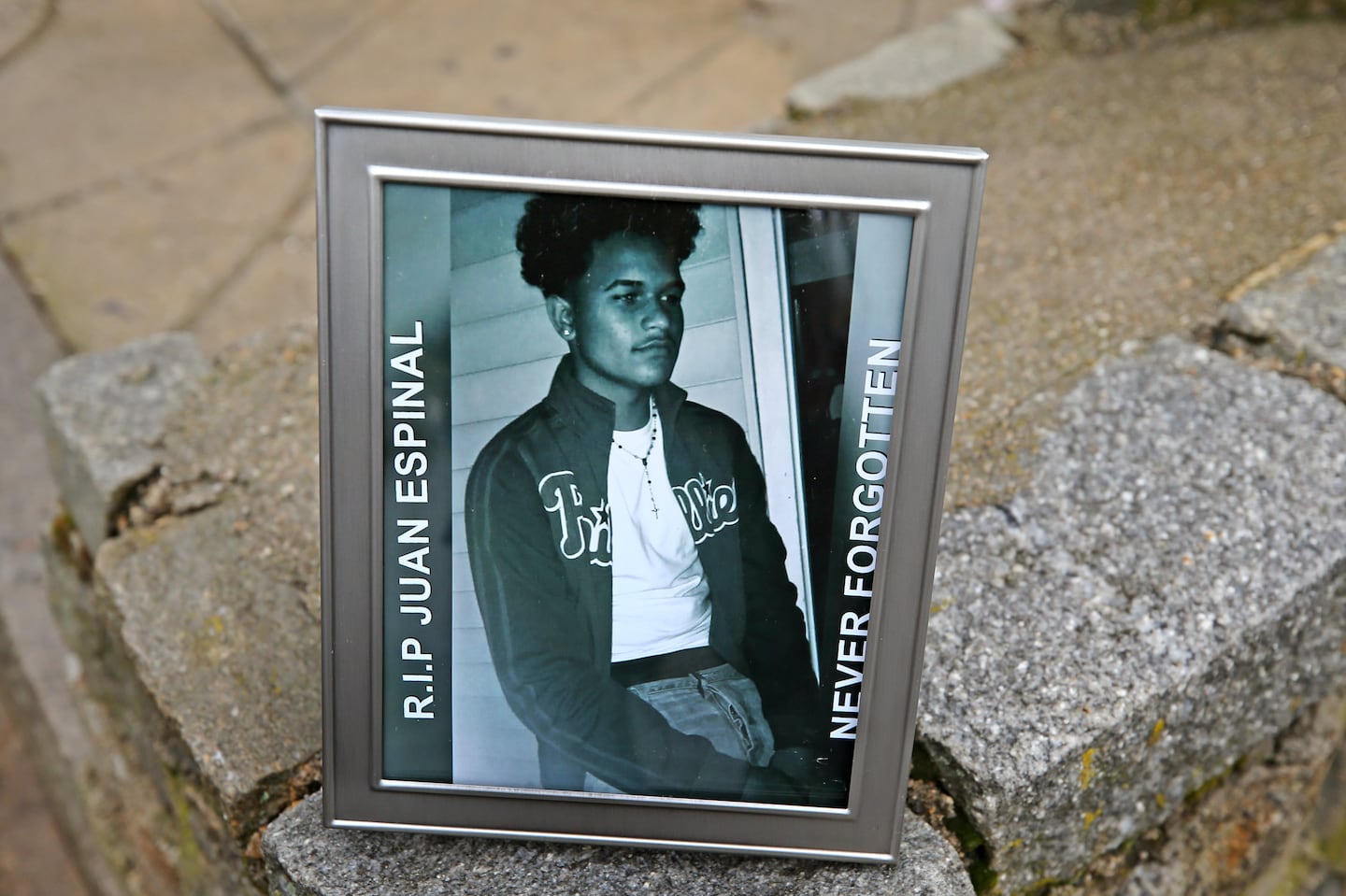 In 2017, a photo of Juan Espinal, 18, was placed at memorial for him at 49 Forest St. in Lawrence.