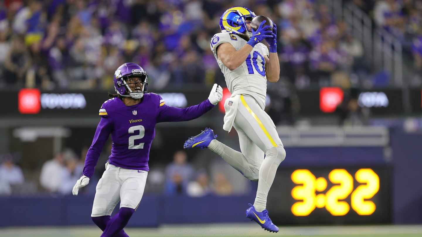 Rams wide receiver Cooper Kupp (10) goes up high to bring in a Matthew Stafford pass in front of Vikings cornerback Stephon Gilmore in the second half of Los Angeles' win on Thursday Night Football.