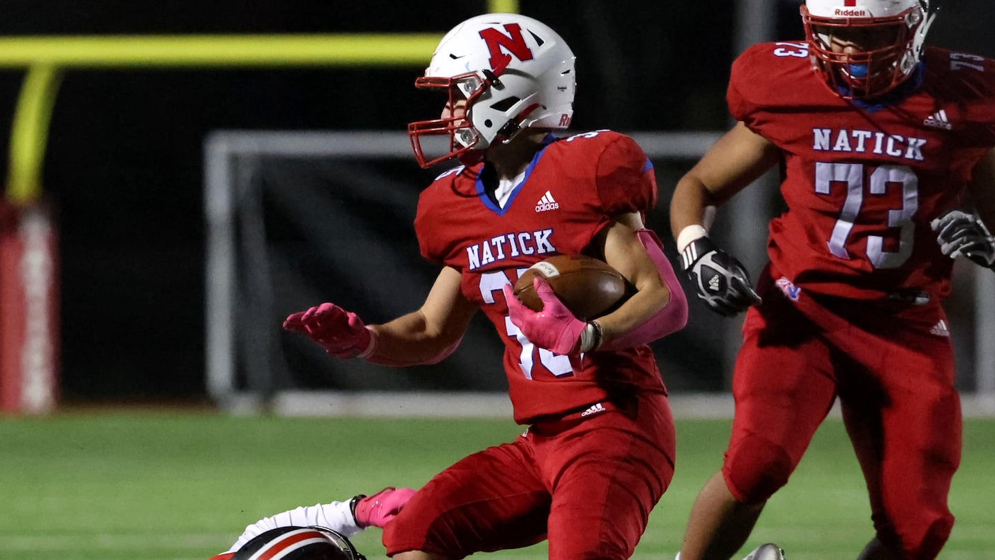 Natick's Jack Showstead attempts to elude Wellesley defender Jake Broggi (7) in the first half of Friday's Bay State Conference matchup.