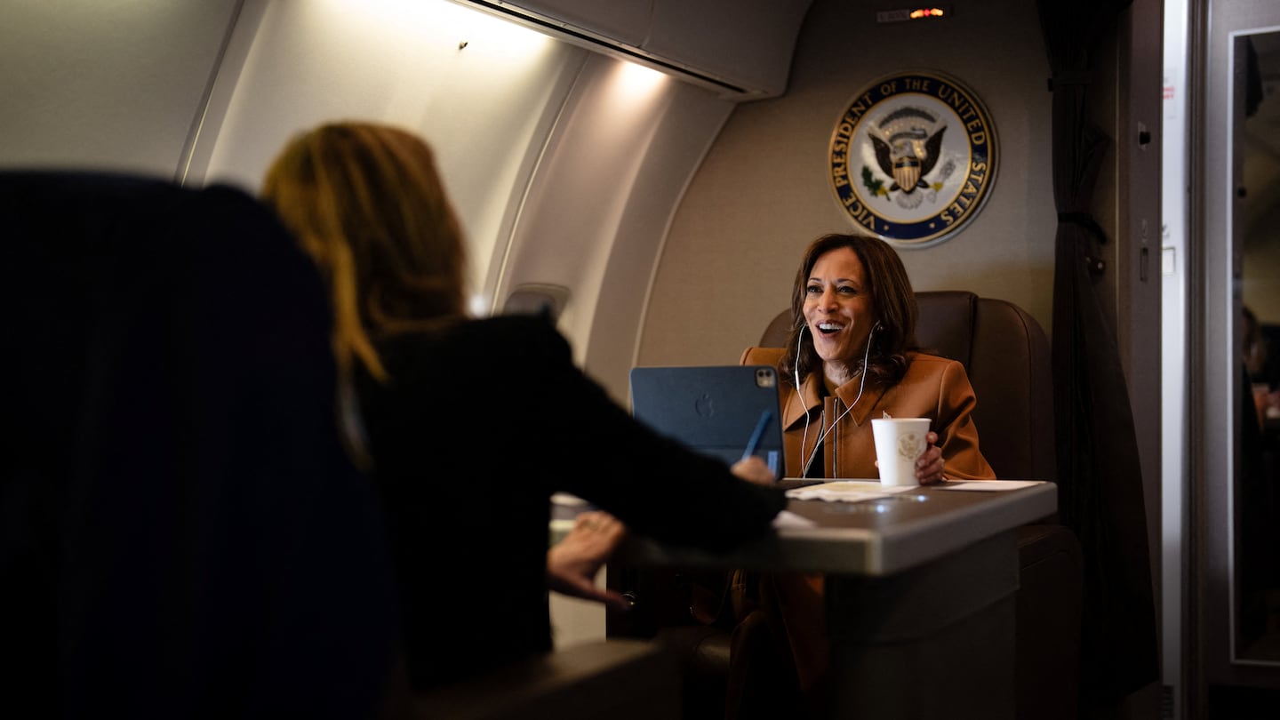 US Vice President Kamala Harris works aboard Air Force Two while on a call en route from Houston, Texas, to Kalamazoo, Michigan, on October 26, 2024.