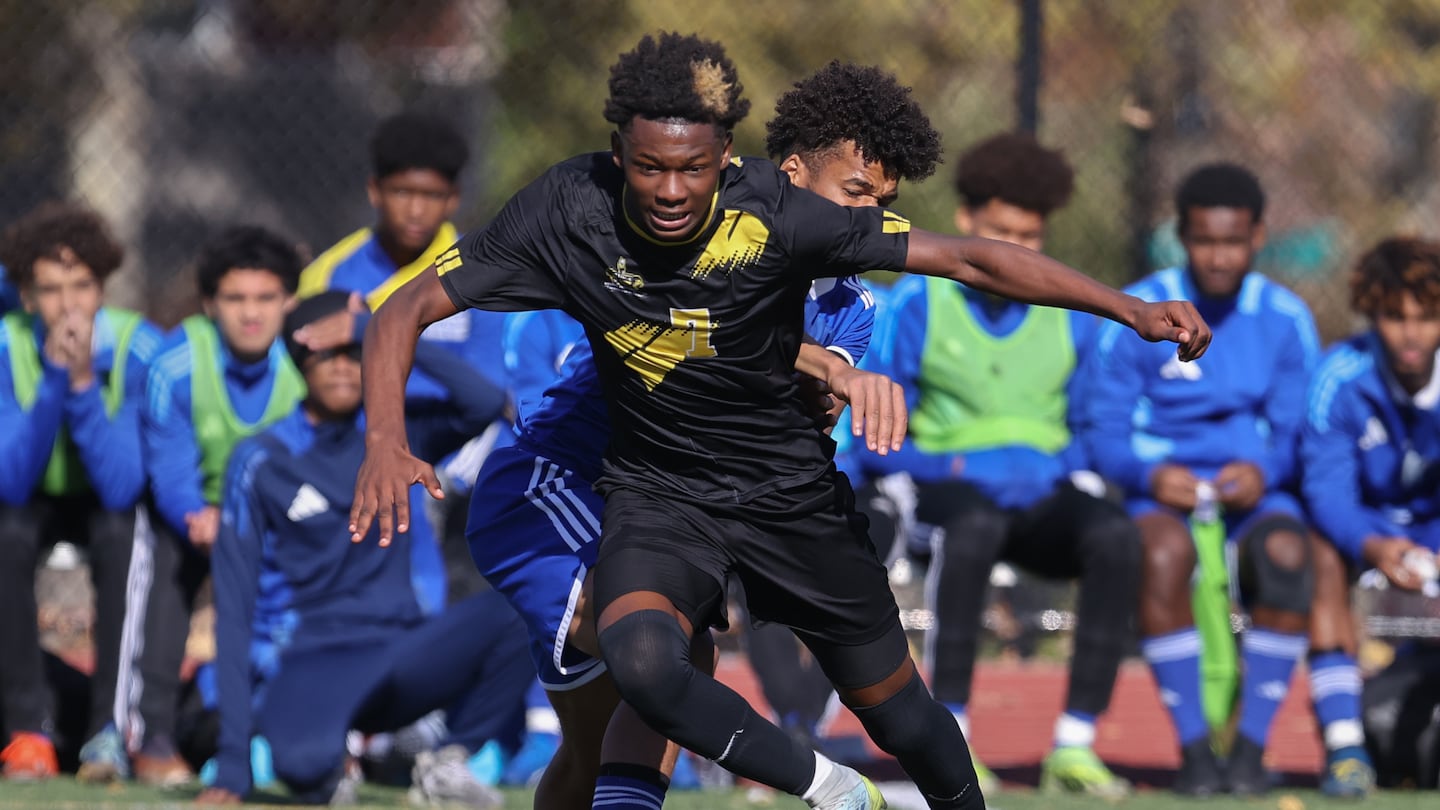 Boston International's Jerry Registe spins off a Dearborn STEM defender during his two-goal outing in Saturday's Boston City Championship game at Madison Park. 