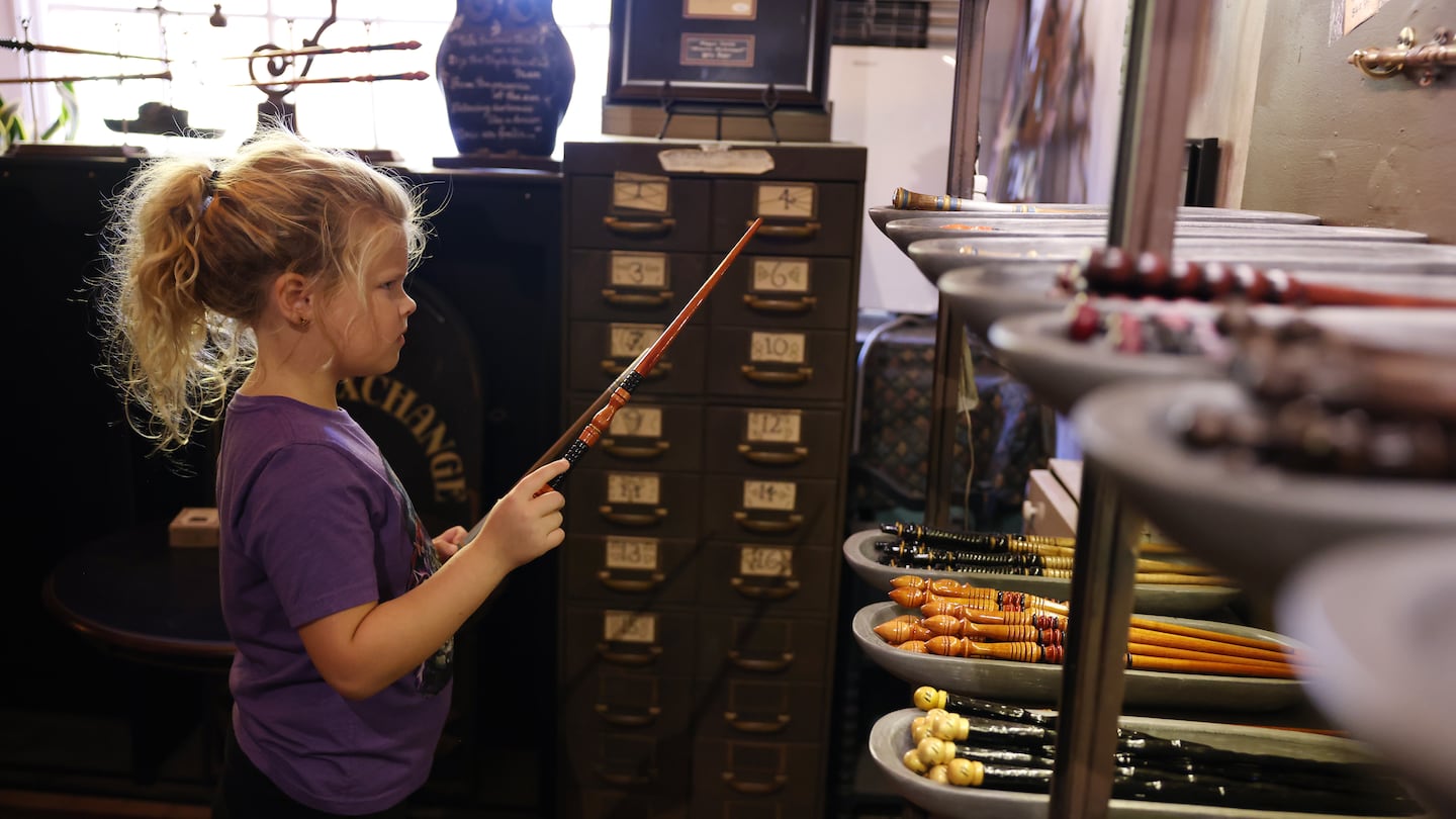 Dylan Hall, 7, of Louisville, Ky., tried to decide between two different wands inside Wynott’s Wands in Salem.