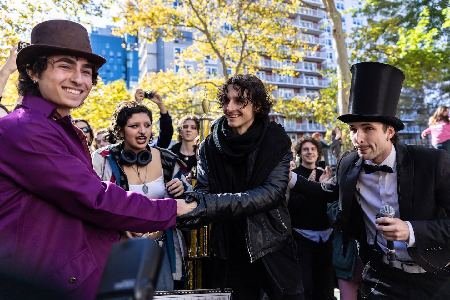 Finalists Miles Mitchell, left and Zander Dueve, center, shake hands at the Timothée Chalamet look-alike contest near Washington Square Park, Sunday, Oct. 27, 2024, in New York.