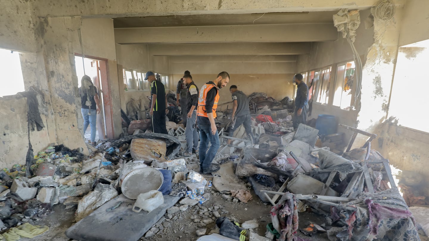 Palestinian people and rescue team members inspect after an Israeli attack on a school sheltering displaced people in Nuseirat refugee camp in Deir al-Balah, Gaza Strip on Oct. 24, 2024.