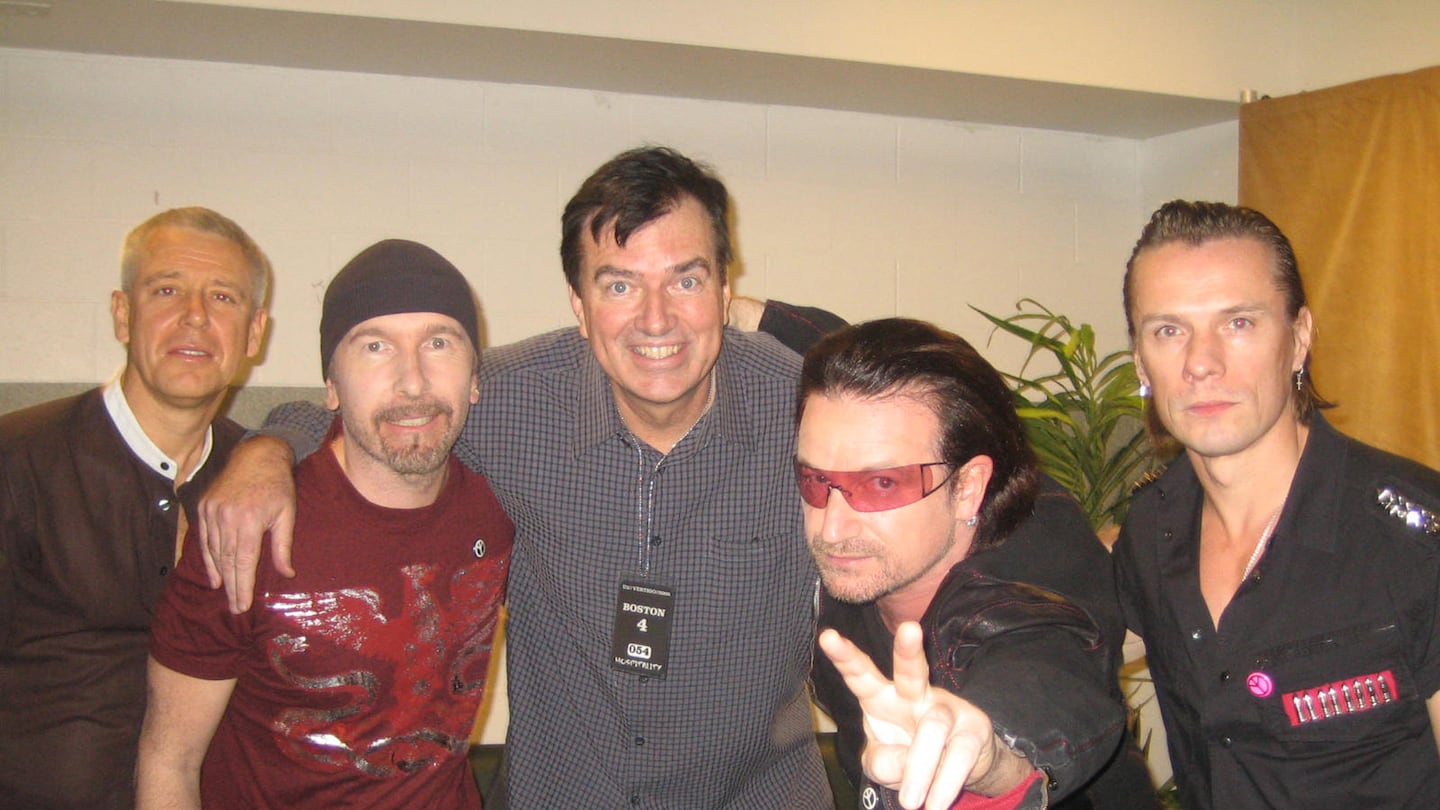 Former Boston Globe music critic and writer Steve Morse (center) with U2