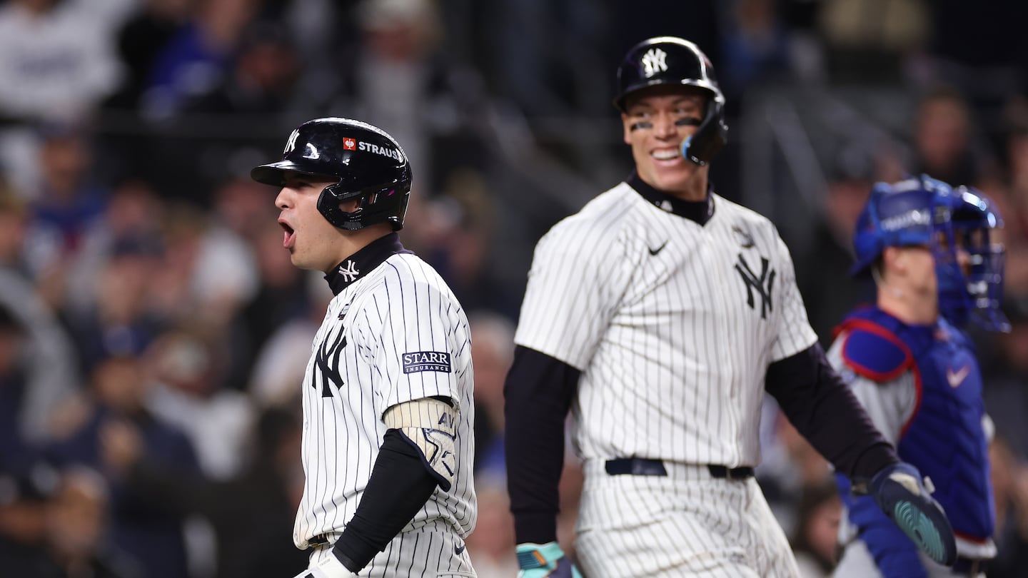 Aaron Judge congratulates Anthony Volpe (left) after the Yankees shortstop blasted a grand slam in third inning of Game 4 of the World Series Tuesday night at Yankee Stadium.