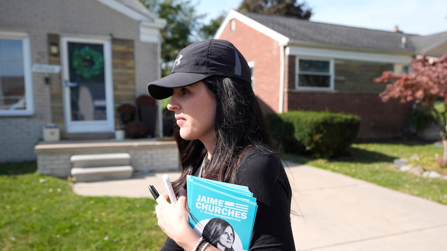 Democratic state Representative Jaime Churches who seeks a second term in the state House campaigns door to door, Oct. 11, in Trenton, Mich.