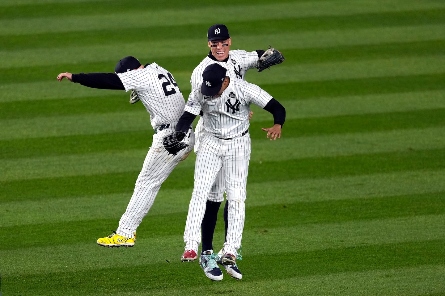 (From left) Alex Verdugo, Aaron Judge, and Juan Soto got some air after the Yankees won Game 5.