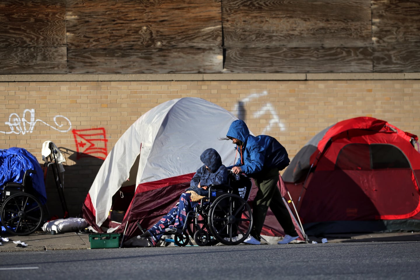 People walked by tents lined up on Southampton Street near the intersection known as Mass. and Cass in Boston in 2021.