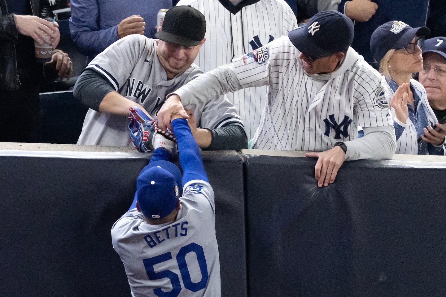 Fans interfered with Mookie Betts of the Los Angeles Dodgers during the World Series game at Yankee Stadium on Tuesday night.