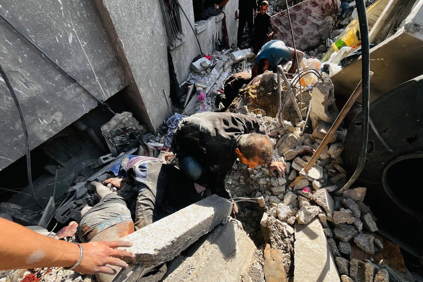 Palestinian recover a body from the rubble of a building hit by an Israeli strike in Beit Lahia, in the northern Gaza Strip, on Oct. 29 amid the ongoing war in the Palestinian territory between Israel and Hamas.