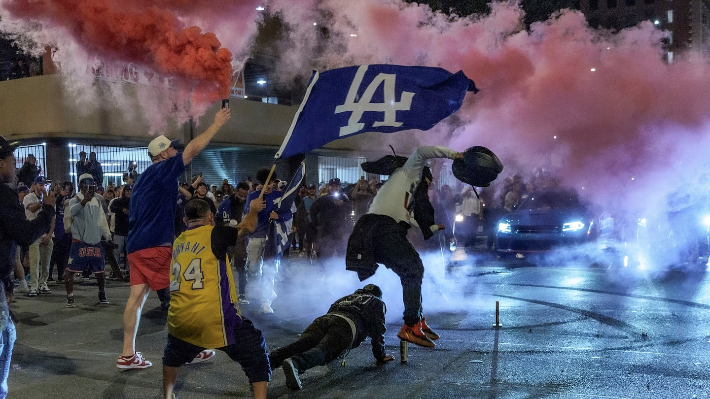 Fans celebrate on the streets after the Los Angeles Dodgers won against the New York Yankees in the baseball World Series on Oct. 30 in Los Angeles.