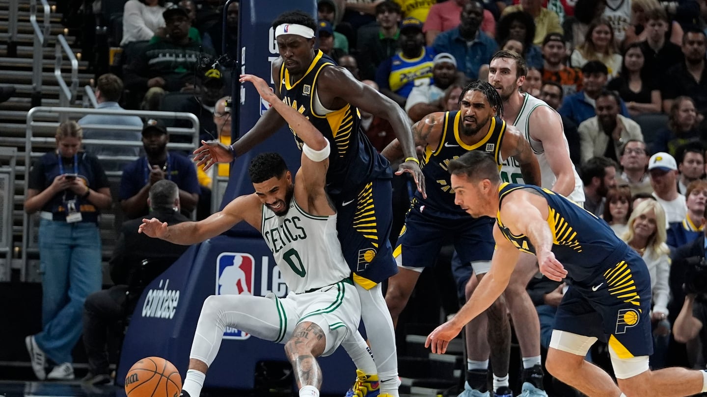 Celtics' Jayson Tatum (No. 0) looses control of the ball against Pacers forward Pascal Siakam (No. 43) and T.J. McConnell (No. 9) during the second half of Wednesday's 135-132 overtime loss in Indianapolis.