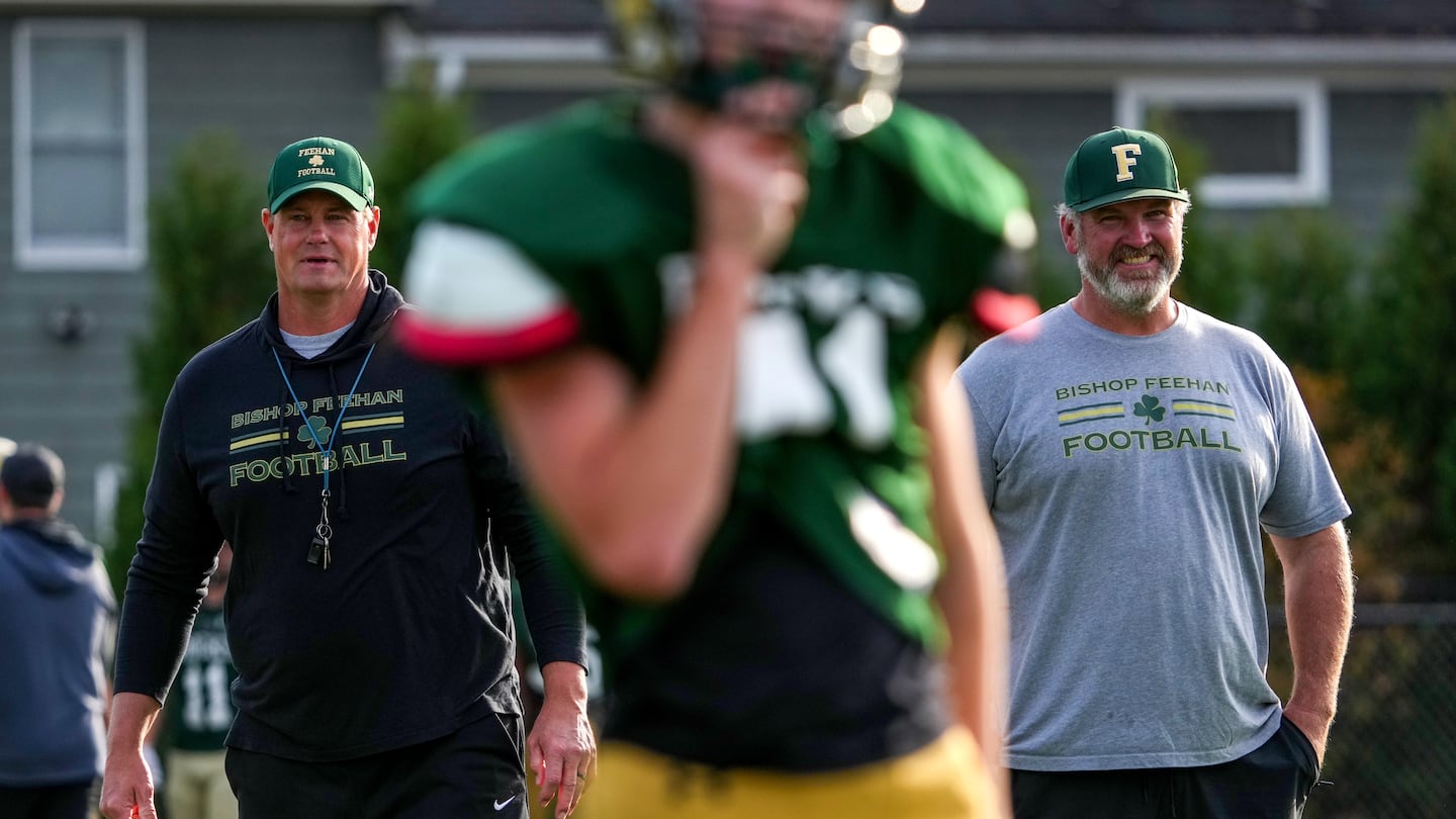 Former Patriots linemen Ross Hochstein (left) and Logan Mankins (right), "have done a good job of balancing their knowledge with what you can teach at the high school level, and that’s been a huge difference this year, the continuity up front," said Bishop Feehan coach Bryan Pinabell.