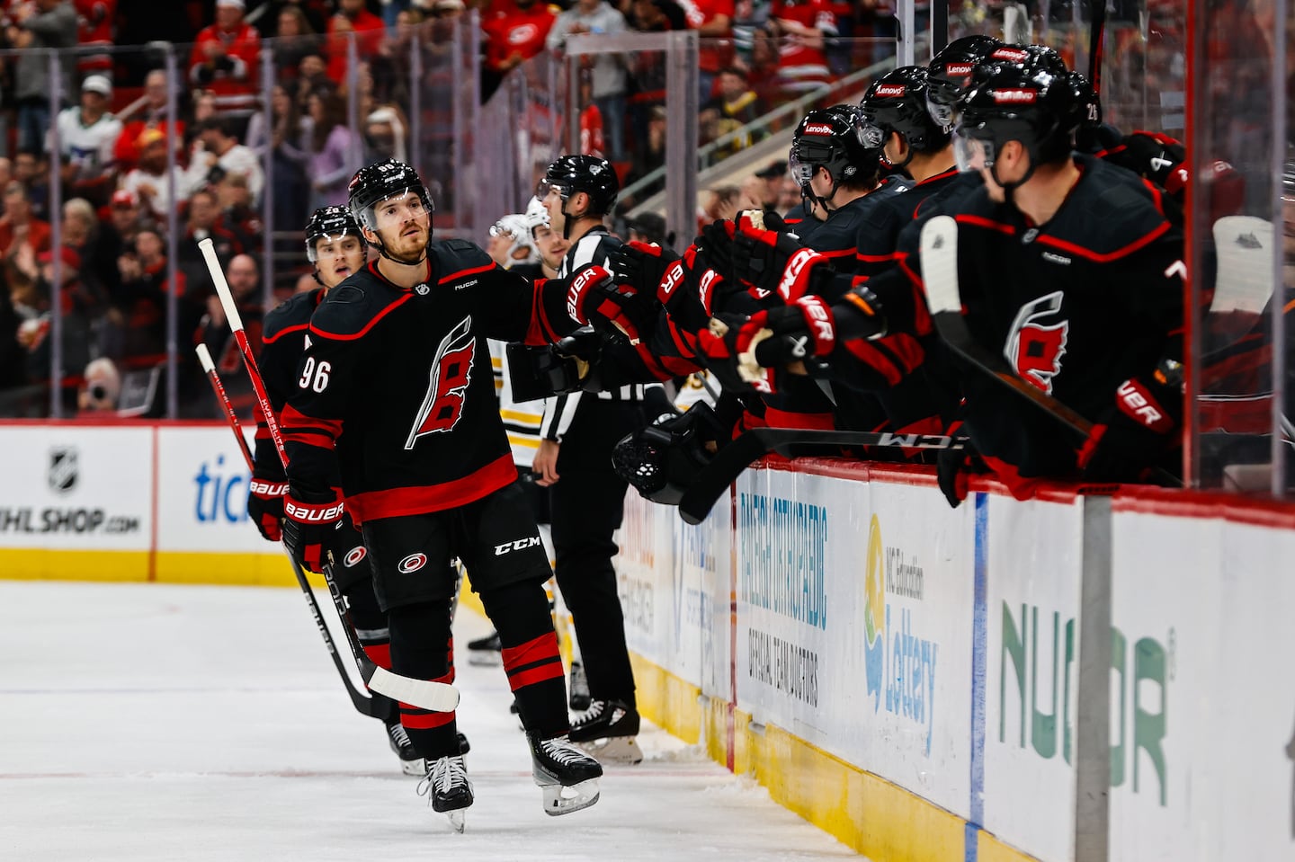 Jack Roslovic (96) cruises past the Hurricanes' bench to be congratulated following his first-period goal.