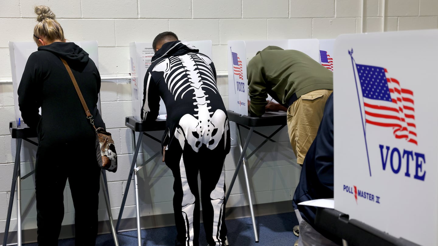 A voter ready for Halloween voted Thursday at the St. Charles County Election Authority in St. Charles, Mo.