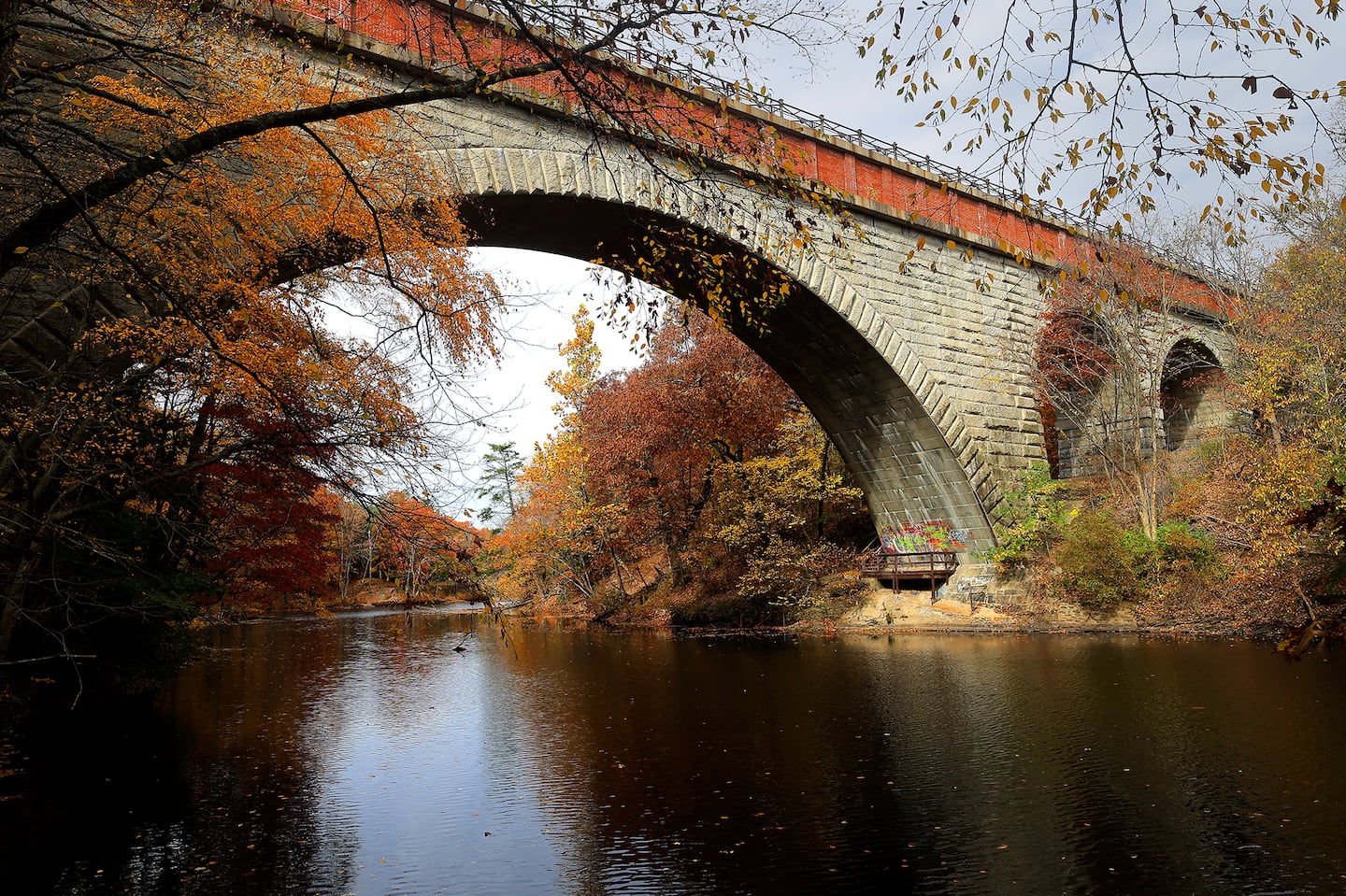 Beneath the Echo Bridge, fall foliage lined the banks of the Charles River in the Hemlock Gorge Reservation in Newton’s Upper Falls.