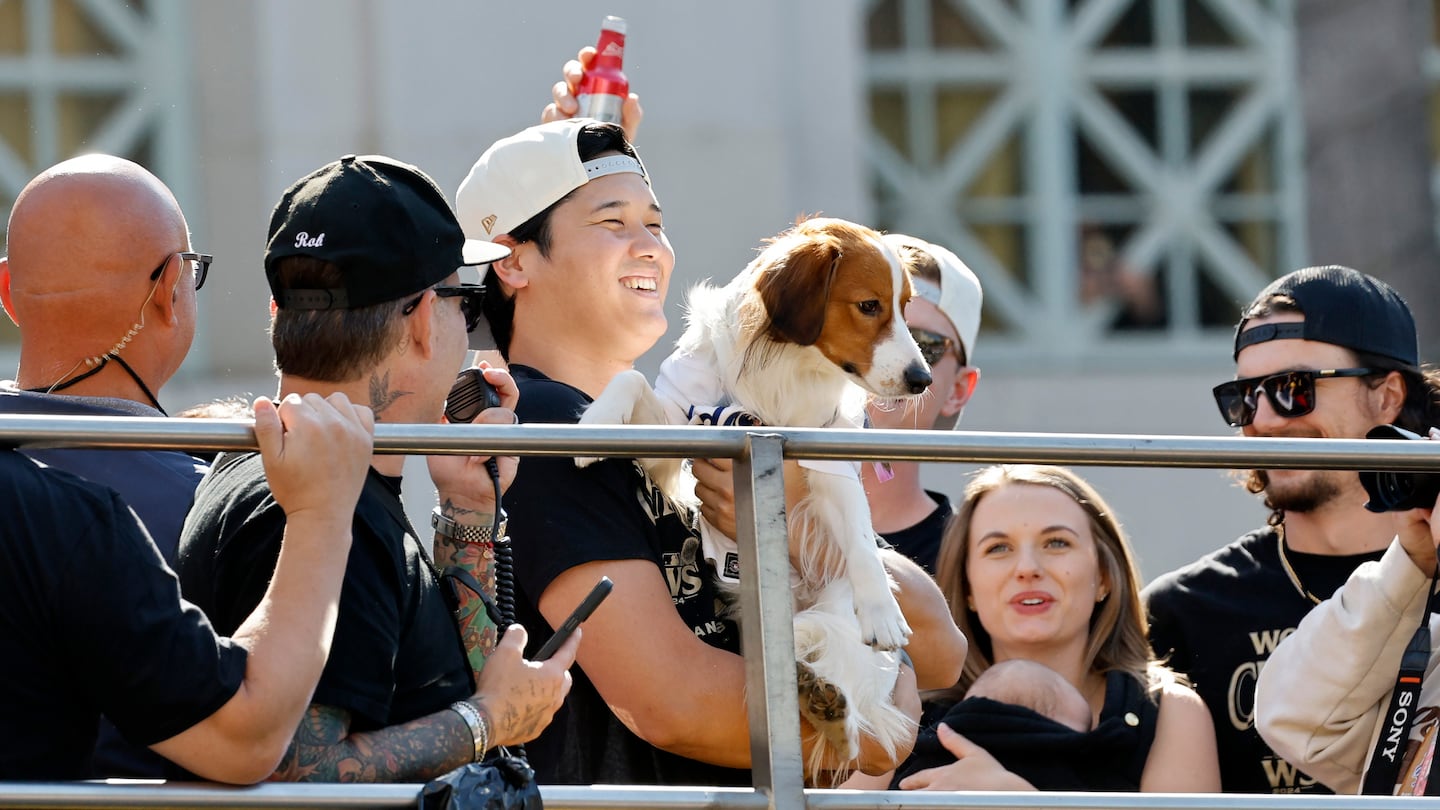 Shohei Ohtani was all glee while holding his dog, Decoy, during the Dodgers' championship parade.