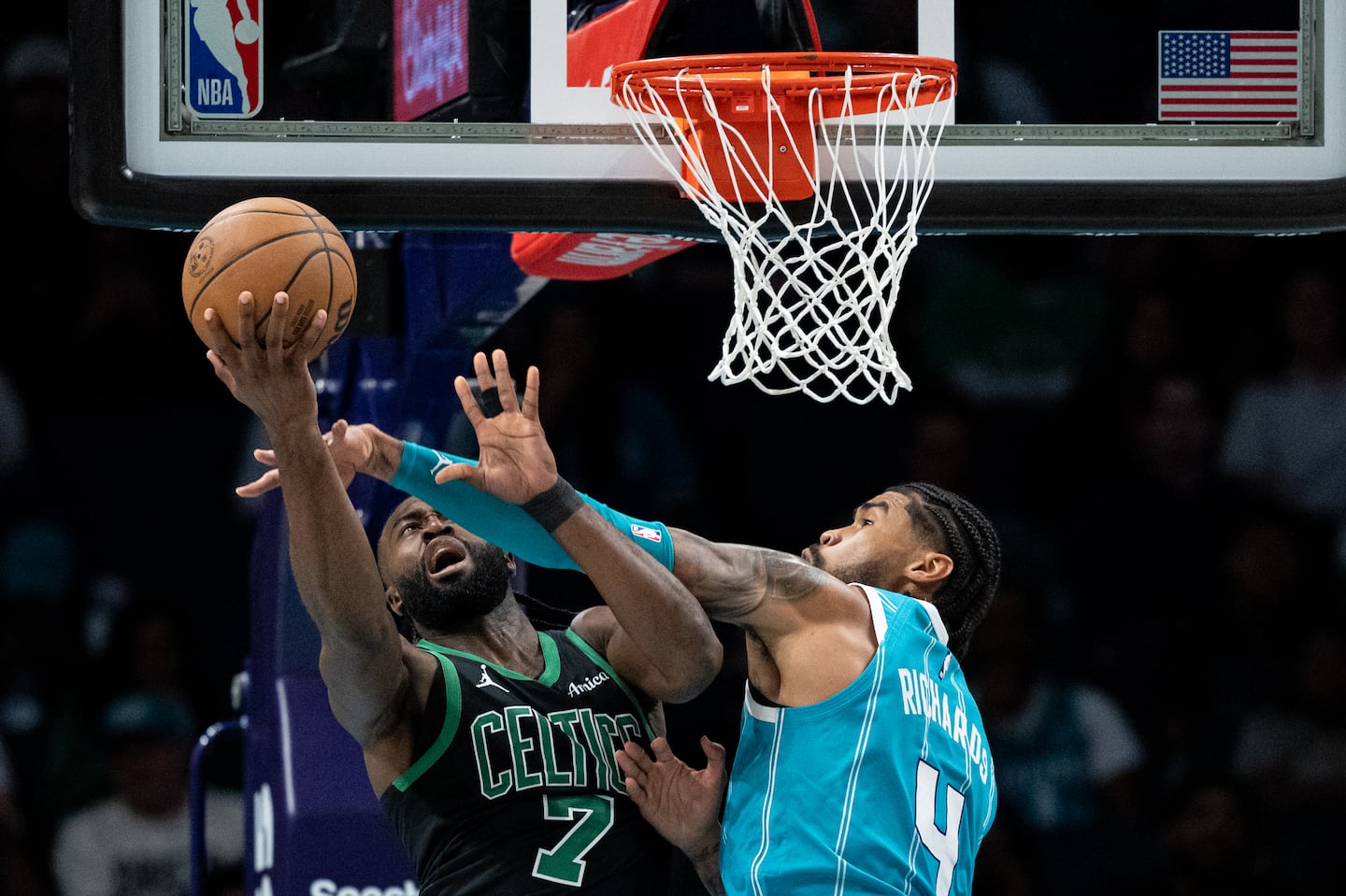 Jaylen Brown gets hacked by the Hornets' Nick Richards during Friday night's physical affair in Charlotte. 