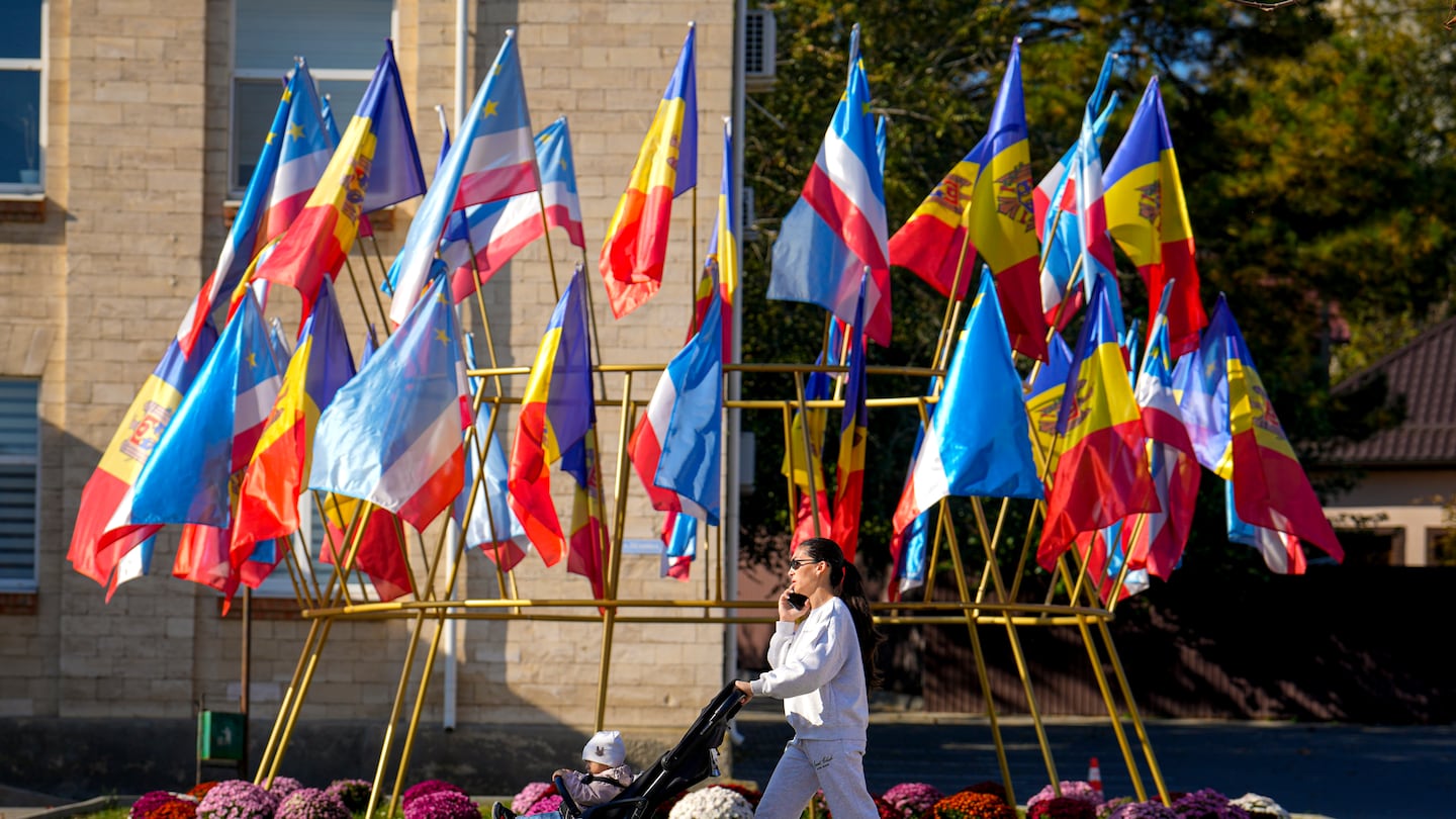 A woman walked past Moldovan and Gagauz flags in Comrat, the capital of Gagauzia, an autonomous part of Moldova, on Saturday.