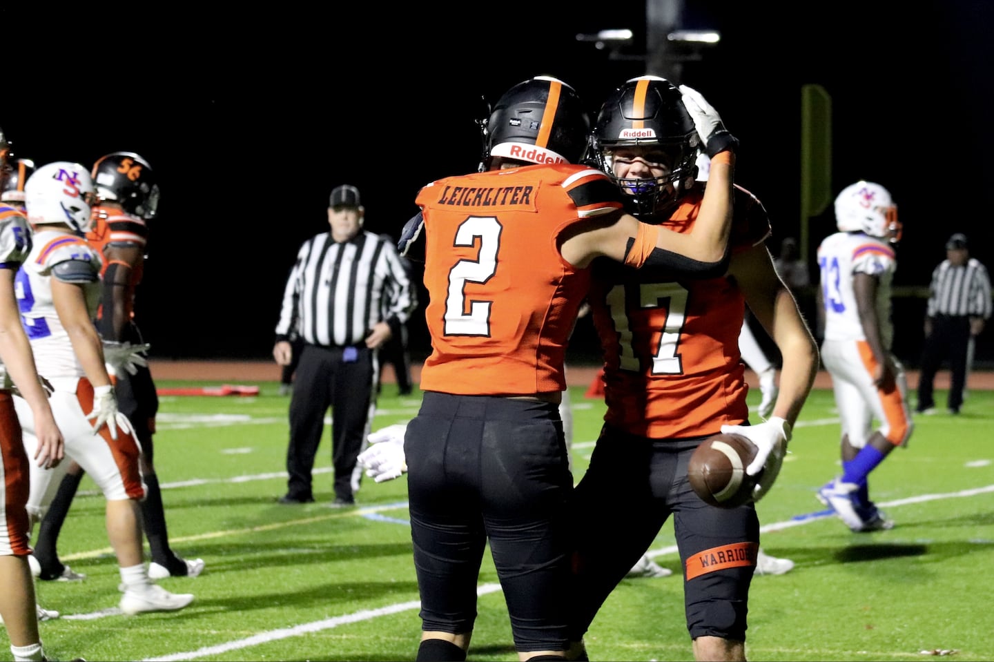 Wayland seniors Braden Leichliter (No. 2) and Jamie Buffum (No. 17) celebrate after a play during a 62-20 win against visiting Newton South on Friday night.