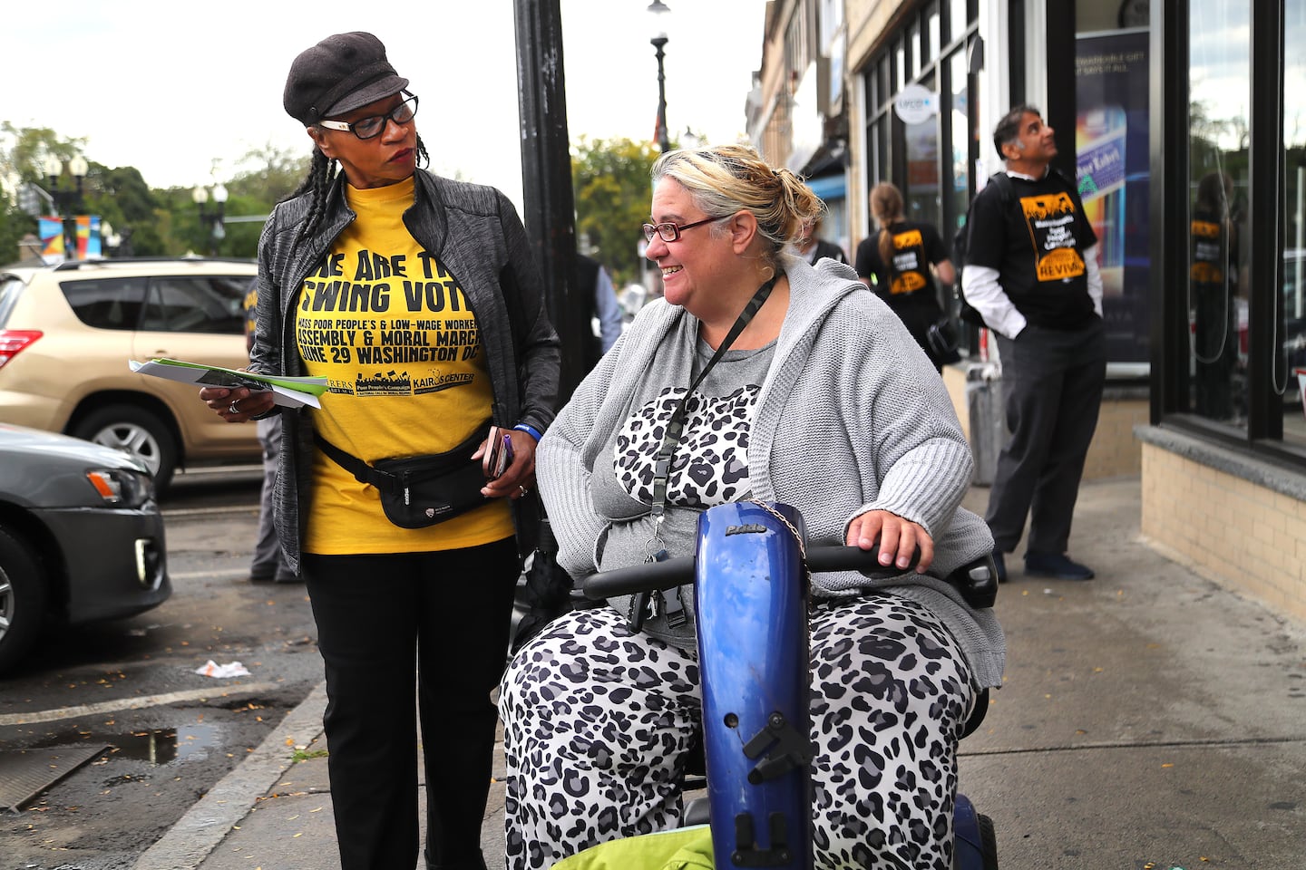 Poor People's Campaign volunteer Savina Martin (left) talked to Michelle Vargas in Mattapan Square in early October as part of an effort to mobilize low-income voters. 