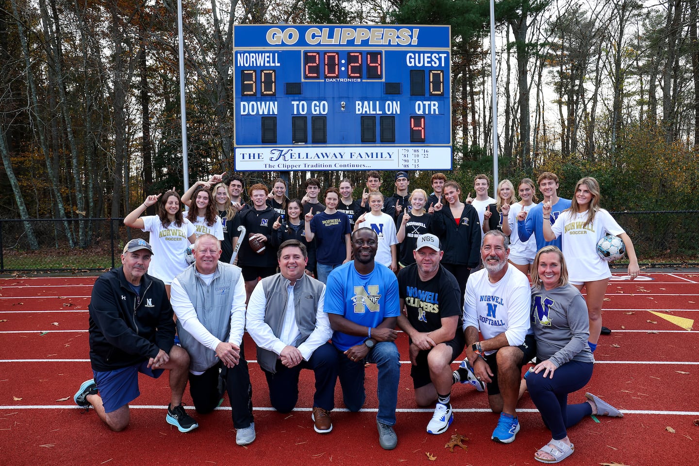 Through the work and dedication of athletes, administrators, and coaches at Norwell High, athletic director JJ Niamkey (center) and the Clippers celebrated 221 regular-season wins in 2023-24, and another Globe Ames Division 4 trophy.