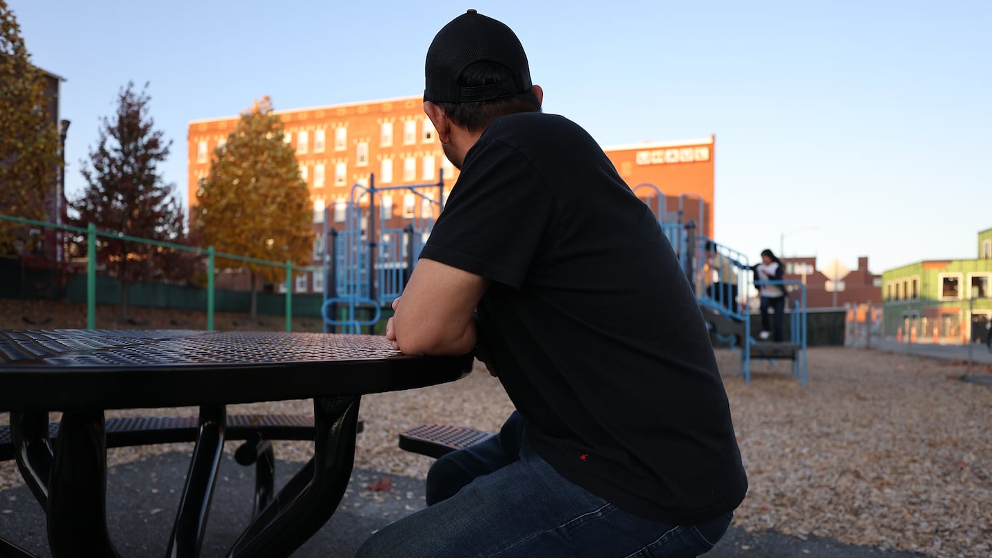 Alexander, a recent migrant from Ecuador, and his three children are living in a shelter in Holyoke. At times they have lived in his car. He watched his children play in a playground.