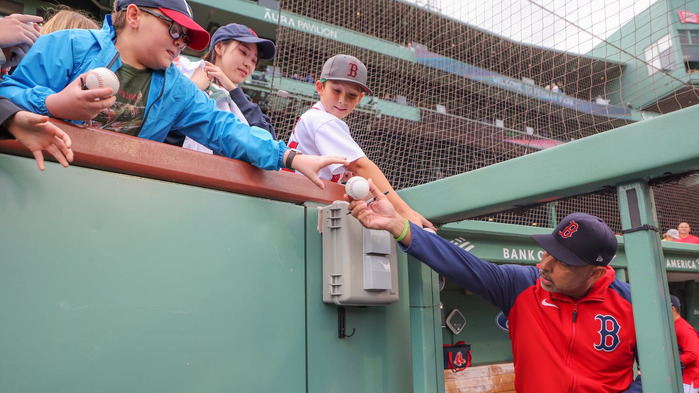 Red Sox manager Alex Cora signed some autographs before one of the final games of the season at Fenway Park.