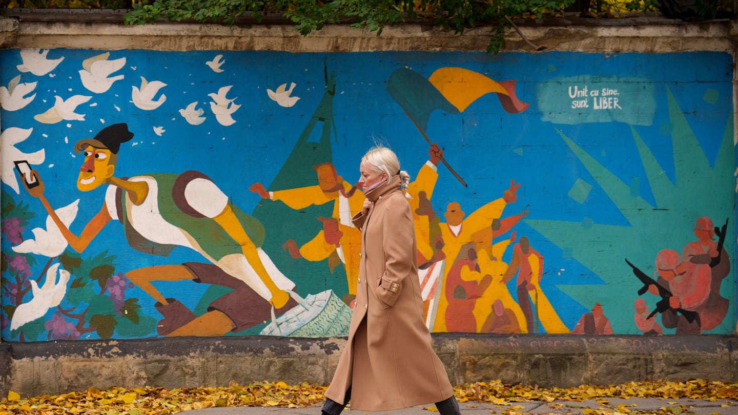 A woman walked by graffiti done in 2016 by Moldovan artists celebrating 25 years since the country declared its independence from the Soviet Union, in Chisinau, Moldova, Monday.