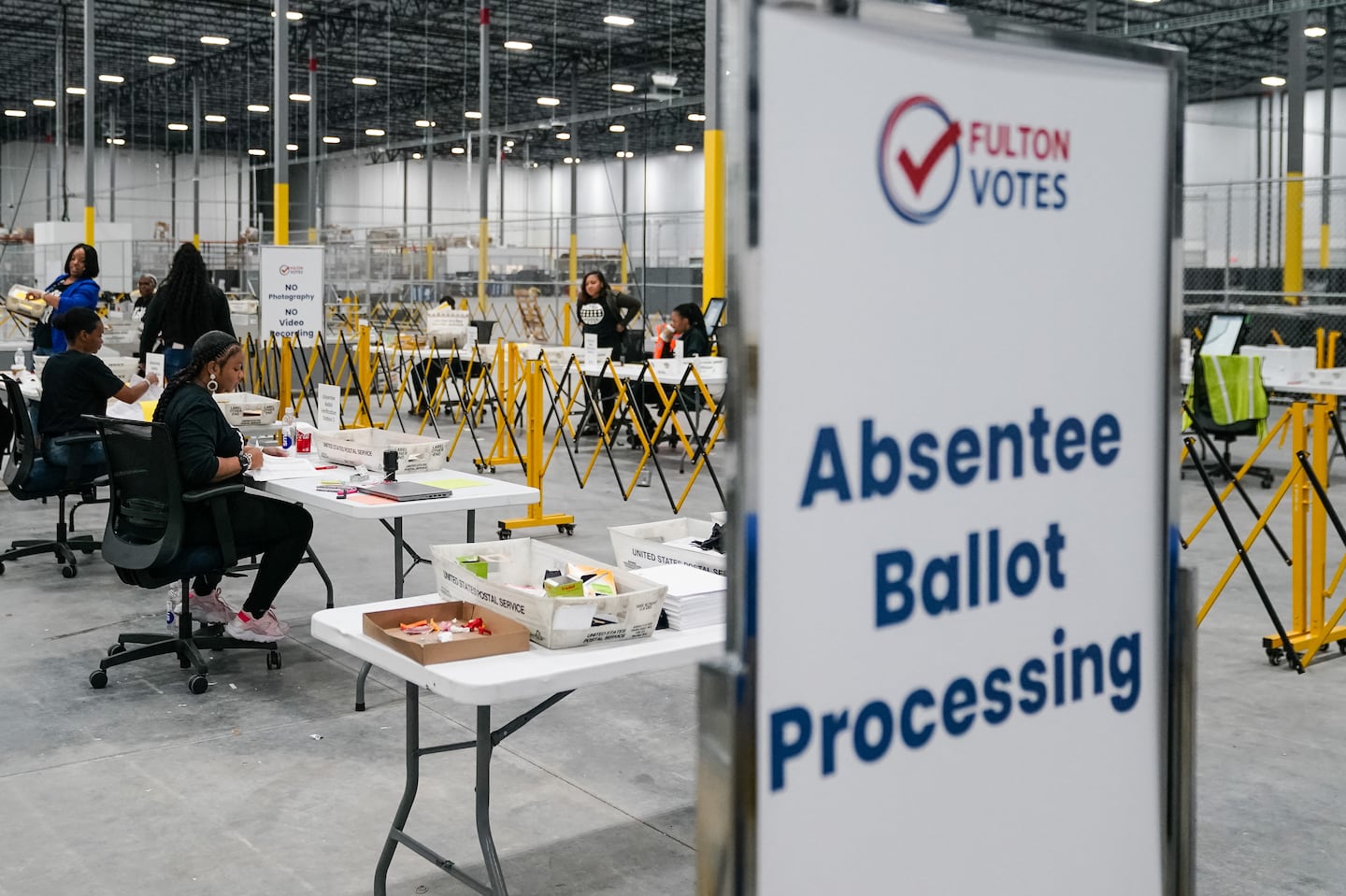 Fulton County elections workers process absentee ballots at the new Fulton County Elections Hub and Operations Center on Nov. 4 in Union City, Georgia.