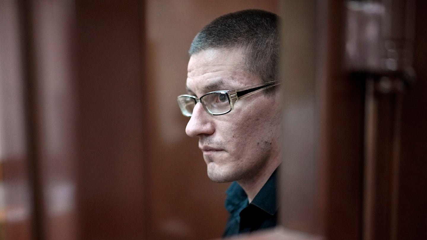 Robert Woodland, a Russia-born US citizen, stands in a glass cage during a court hearing, July 4, in Moscow, Russia.