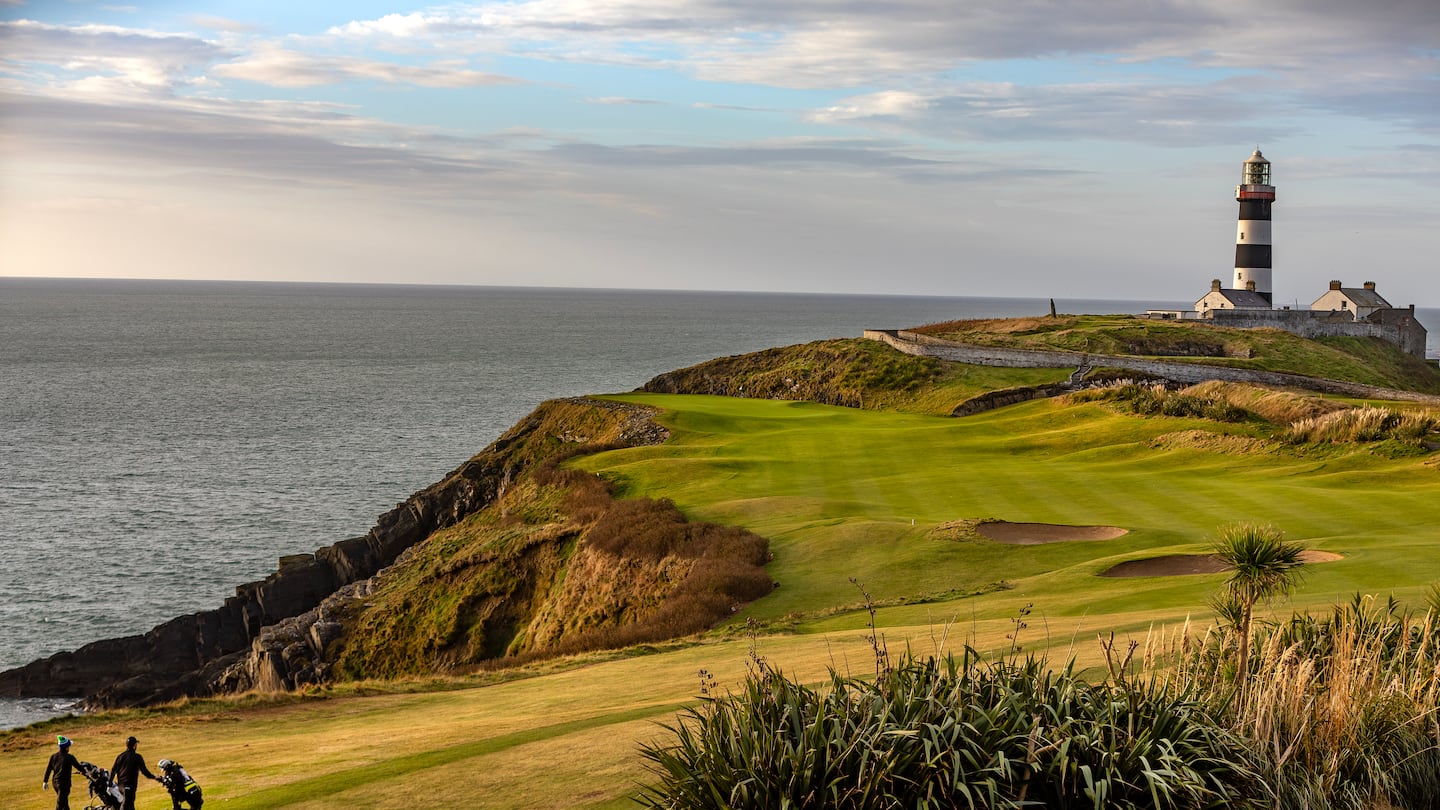 Mark Murphy and Eoin O’Connor walk toward Old Head Light on the 4th hole known as the Razor’s Edge at Old Head in Kinsale, Ireland.