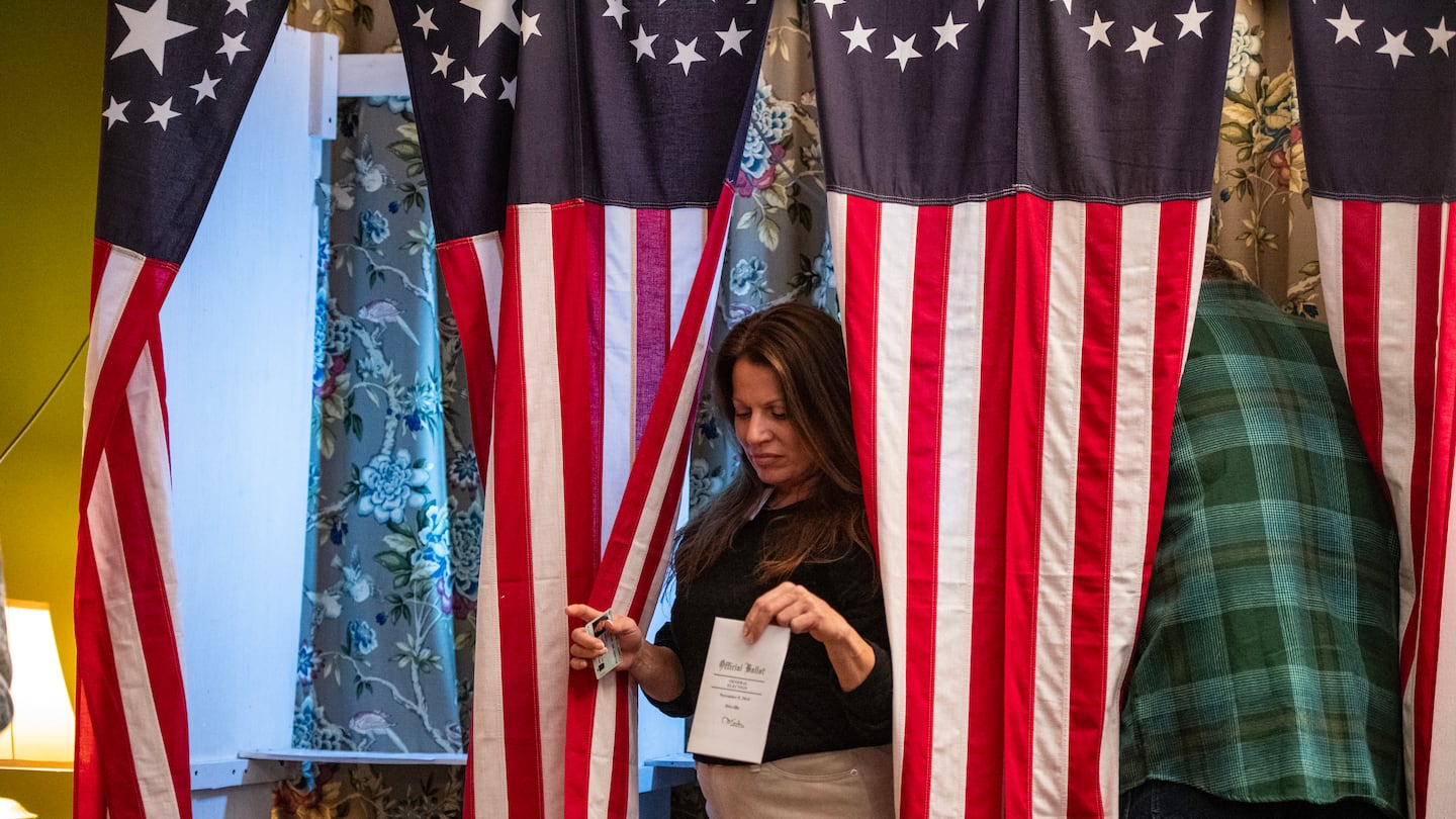 Residents of Dixville Notch cast their ballots in the US election at midnight in the living room of the Tillotson House at the Balsams Grand Resort, marking the first votes in the US election, in Dixville Notch, N.H. on Nov. 5.