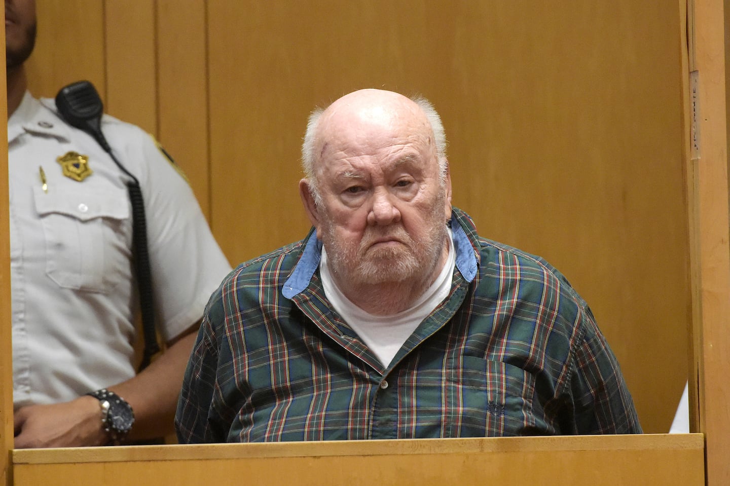 Marvin C. McClendon Jr. stands in the prisoner's dock during his arraignment in Lawrence District Court on May 13, 2022.