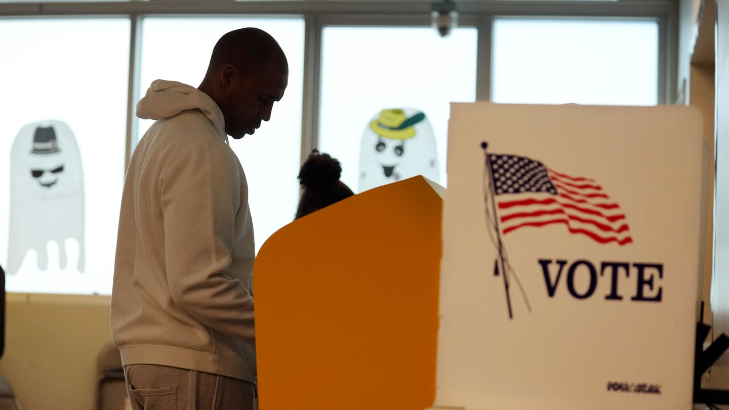 A voter was silhouetted as he worked on his ballot at a polling place at the Michelle and Barack Obama Sports Complex on Election Day, Tuesday in Los Angeles.