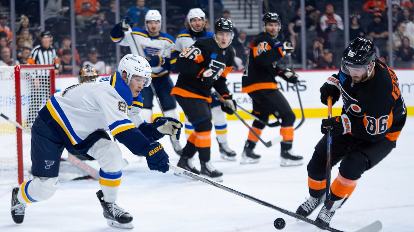 Dylan Holloway (left) of the Blues was taken to the hospital after being struck by a puck late in the first period of Tuesday's game against the Lightning.